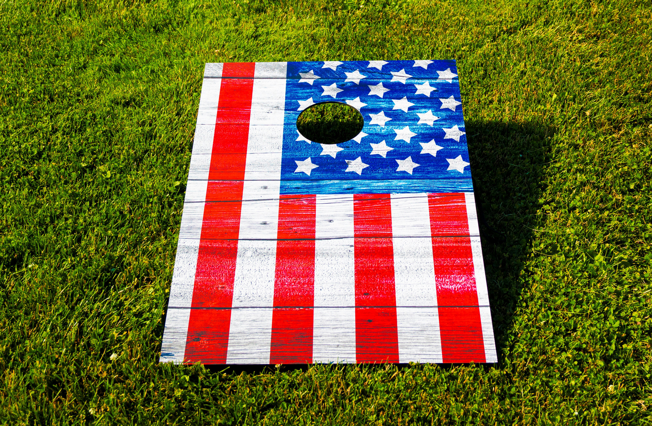 American Flag cornhole game on grass